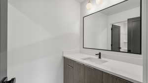 Photos are of a completed unit - Bathroom featuring vanity