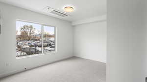 Photos are of a completed unit - Spare room with light colored carpet and baseboards
