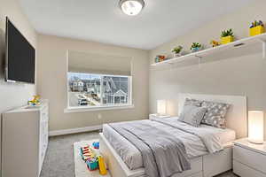 Bedroom featuring light colored carpet and baseboards