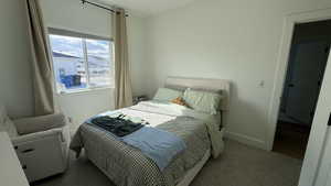 Bedroom with carpet floors and baseboards