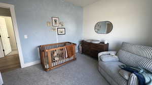 Carpeted bedroom featuring baseboards