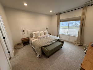 Carpeted bedroom featuring recessed lighting and baseboards