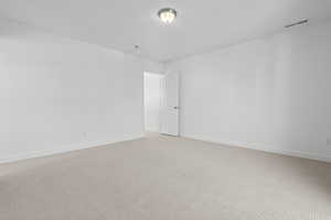 Carpeted empty room with baseboards