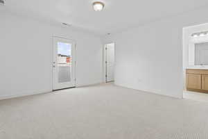 Spare room featuring baseboards and light colored carpet