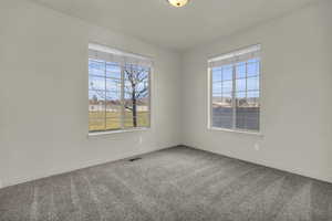 Unfurnished room with carpet and baseboards
