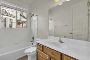 Full bath featuring vanity, tub / shower combination, and light tile patterned floors