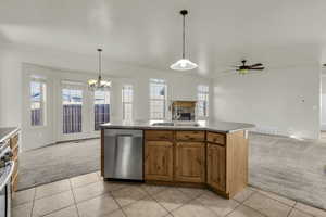 Kitchen featuring light carpet, a kitchen island with sink, and open floor plan