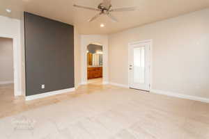 Spare room with ceiling fan, arched walkways, light carpet, and recessed lighting