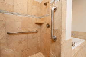 Bathroom with a tile shower and a bath