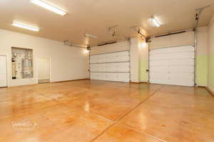Garage with water heater and baseboards