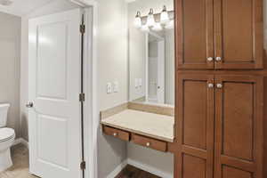 Bathroom with vanity and dark tile patterned flooring
