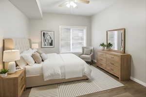 Bedroom with dark wood finished floors and ceiling fan