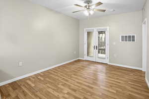 Spare room featuring french doors, a ceiling fan, and light wood finished floors