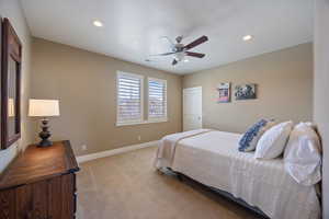Carpeted bedroom featuring a ceiling fan and recessed lighting