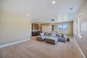 Living area featuring recessed lighting and light carpet