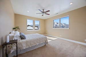 Carpeted bedroom with recessed lighting and ceiling fan