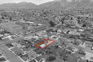 Aerial view of property's location featuring property parcel outlined and a mountain backdrop