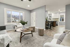 Living room with ceiling fan, light wood finished floors, recessed lighting, and a mountain view