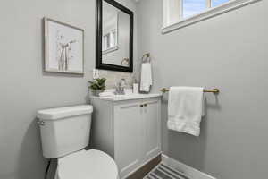 Half bath with vanity and decorative backsplash
