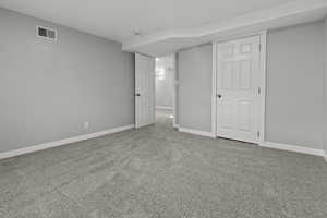Unfurnished bedroom featuring light colored carpet and baseboards