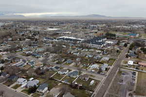 Aerial view of property's location with a mountain backdrop and nearby suburban area