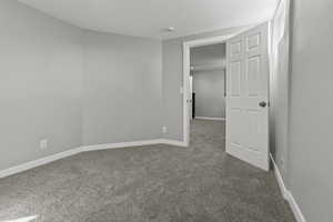 Spare room with carpet flooring and a textured ceiling