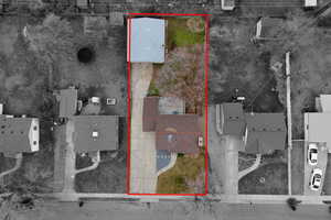 Aerial perspective of suburban area featuring property parcel outlined