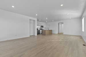 Unfurnished living room featuring light wood-style floors and recessed lighting