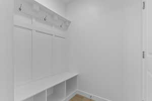 Mudroom featuring baseboards and light wood-type flooring