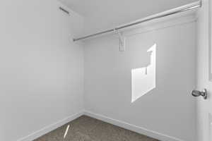 Walk in closet featuring carpet flooring