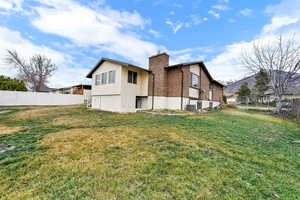 Back of house with brick siding, a chimney, and a mountain view