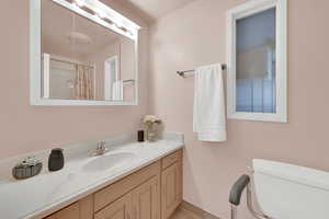 Full bathroom with vanity and a shower with shower curtain