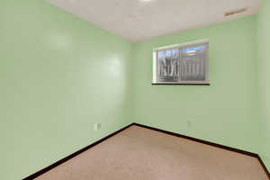 Empty room with baseboards and carpet flooring