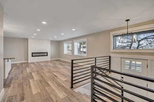 Interior space featuring wood finished floors, a fireplace, and hanging lights