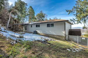 Back of property with brick siding and a gate