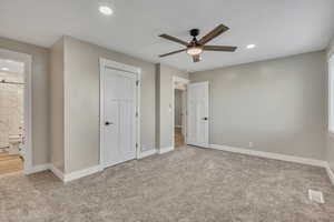 Unfurnished bedroom with light colored carpet, a ceiling fan, recessed lighting, ensuite bathroom, and a closet