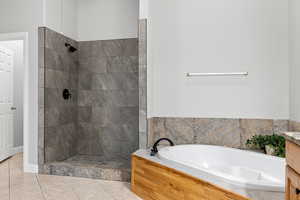 Full bathroom with a bath, vanity, tile patterned floors, and walk in shower