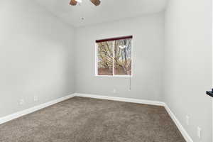 Spare room with carpet flooring and ceiling fan