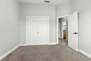 Unfurnished bedroom with carpet floors and a closet