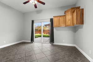 Empty room with a ceiling fan and baseboards