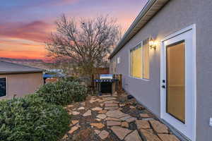 Patio terrace at dusk with a patio area and a grill