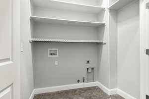 Laundry area with hookup for a gas dryer, hookup for a washing machine, and electric dryer hookup