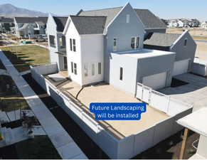 Contemporary multi-story residence featuring a two-tone exterior, a prominent front balcony, and a flat-roof garage structure