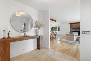 Hall with light tile patterned floors and baseboards
