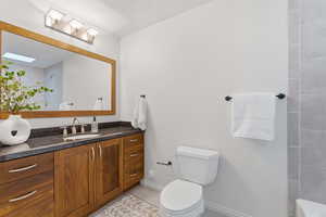 Full bathroom with vanity and light tile patterned floors