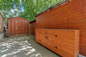 View of patio with a storage shed