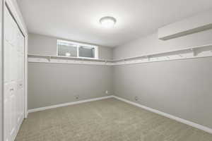 Empty room with light carpet and baseboards