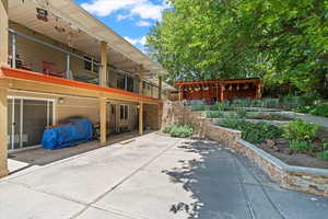 Back of house with a patio area and a balcony
