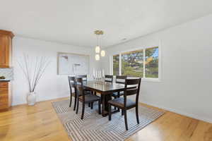 Dining room with light wood-style flooring and baseboards