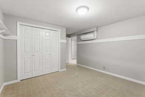 Finished below grade area featuring light carpet and baseboards
